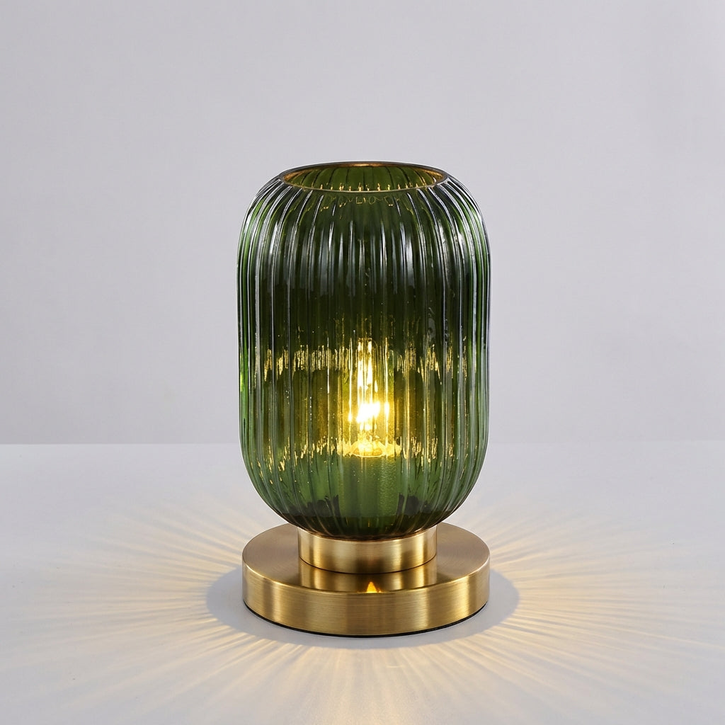 Glintora ribbed glass table lamp, a modern home decor piece, casting soft light in a living room setting.