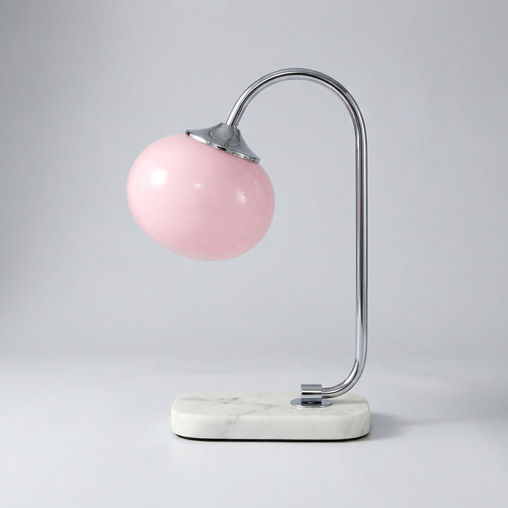 Aesthetic Melluma modern rounded table lamp, adding a touch of sophistication to a bedside table.