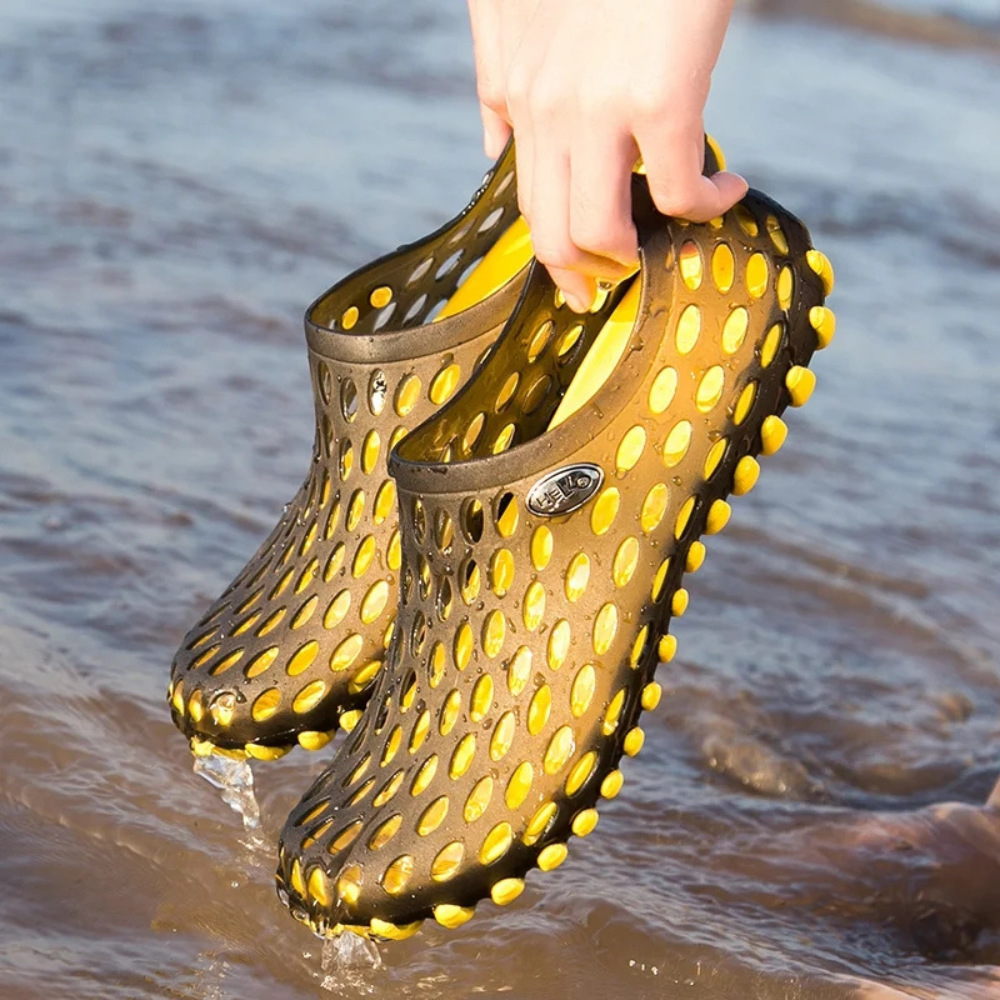 Non-slip sole of a quick-dry water shoe, designed for secure grip on wet surfaces at the beach or pool.