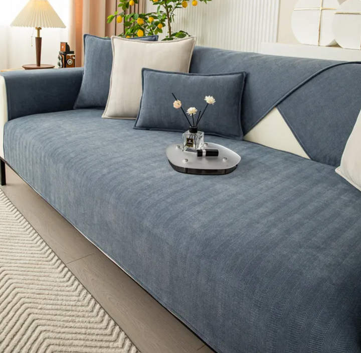 Textured plush chenille herringbone sofa cover providing a sophisticated look and furniture protection.