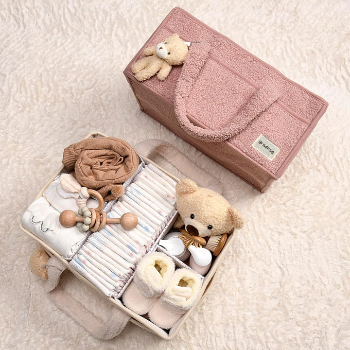Pink sherpa baby caddy with a tiny pair of baby socks, adding a sweet touch to storage