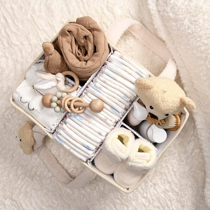 Pink sherpa baby nappy caddy on a bed, keeping essentials close for overnight feeds