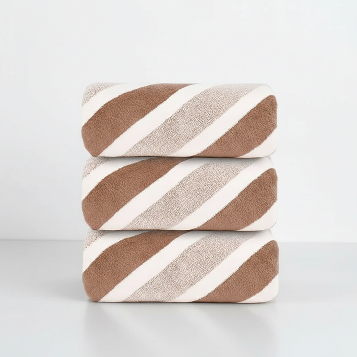Unisex fleece bath towel draped, showing its soft, absorbent properties and knitted fabric design.