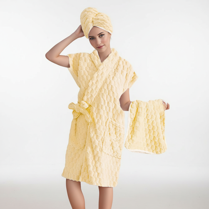 Elegant women's microfiber loungewear bathrobe and towel set, presented folded on a wooden surface.