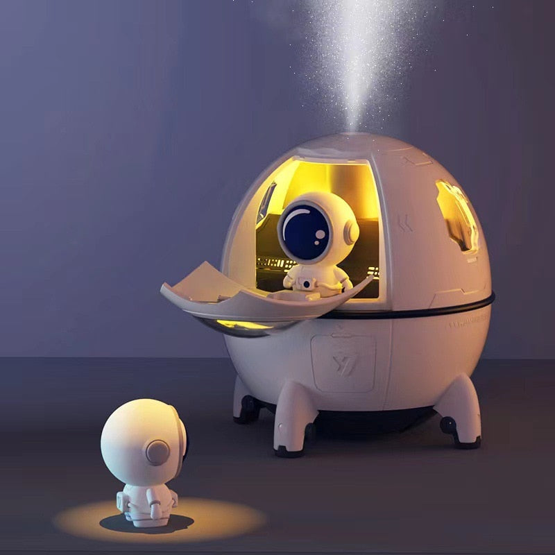 Pink portable astronaut humidifier & aroma diffuser with LED night light. USB rechargeable, soothing home decor.