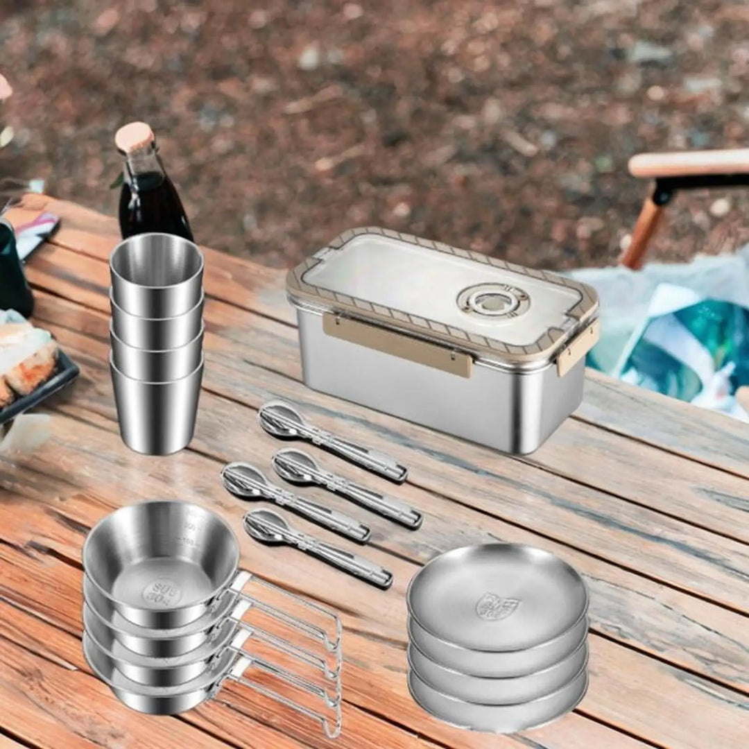Complete portable camping dinnerware set made of stainless steel, neatly packed in a storage box for travel and hiking.