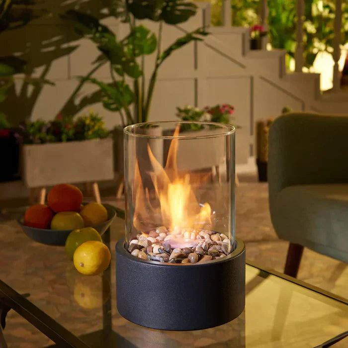 Portable tabletop fire pit lantern, modern design, creating ambiance for outdoor garden decor.