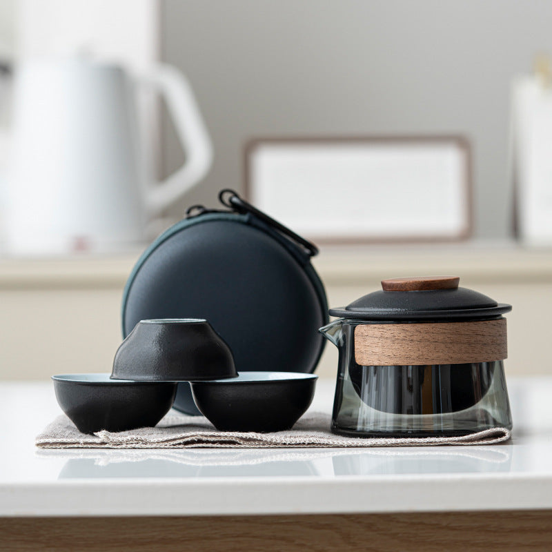 Elegant portable ceramic tea set with glass teapot & 3 matching cups, perfect for enjoying tea anywhere.