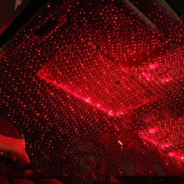 Portable USB Star Projector Ambient Light, StarGlow, for car or bedroom decor, creating a starry night sky effect.