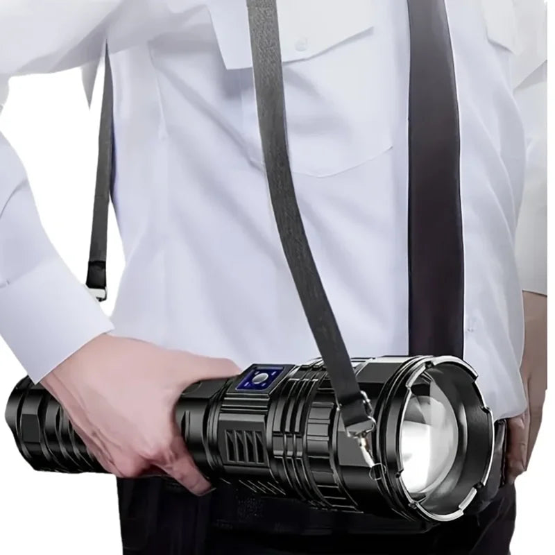 Rechargeable 10000 lumen LED torch, front view, in hand for scale, outdoor gear