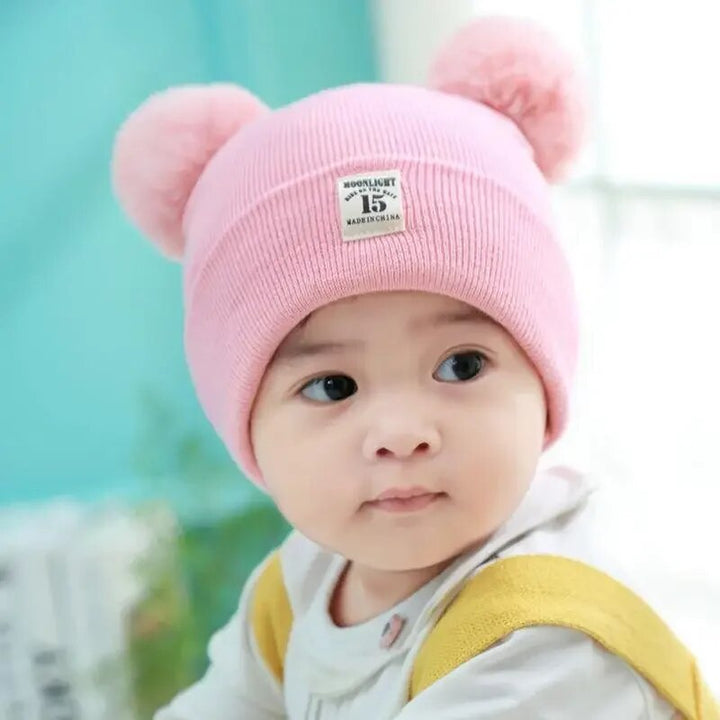 Cozy blue knitted kids' winter hat featuring a large pom pom, ideal for toddlers and children