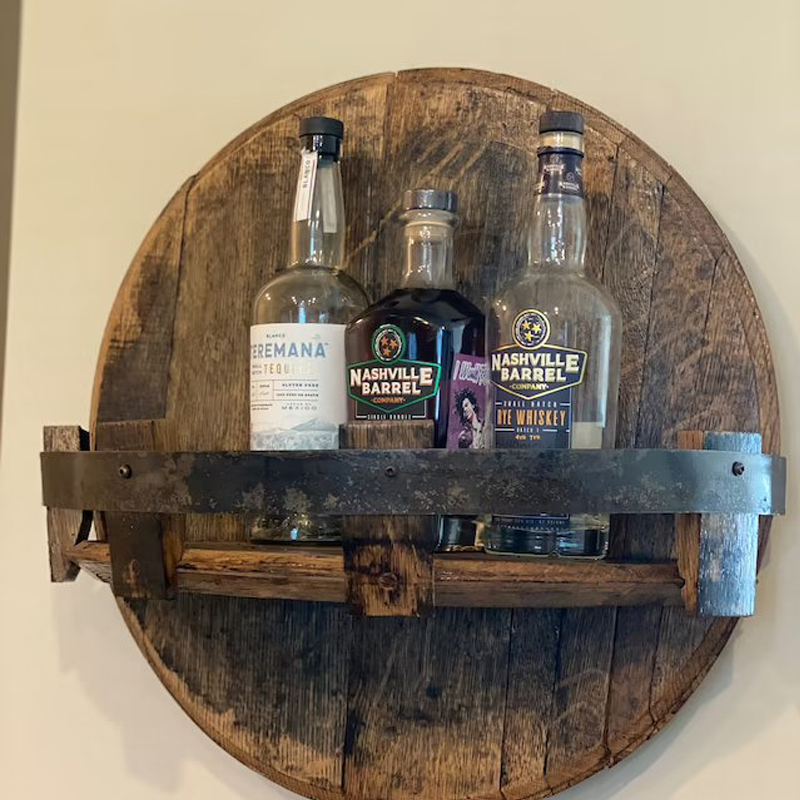 Wall-mounted bourbon barrel shelf featuring authentic oak wood and vintage metal bands, home bar decor.