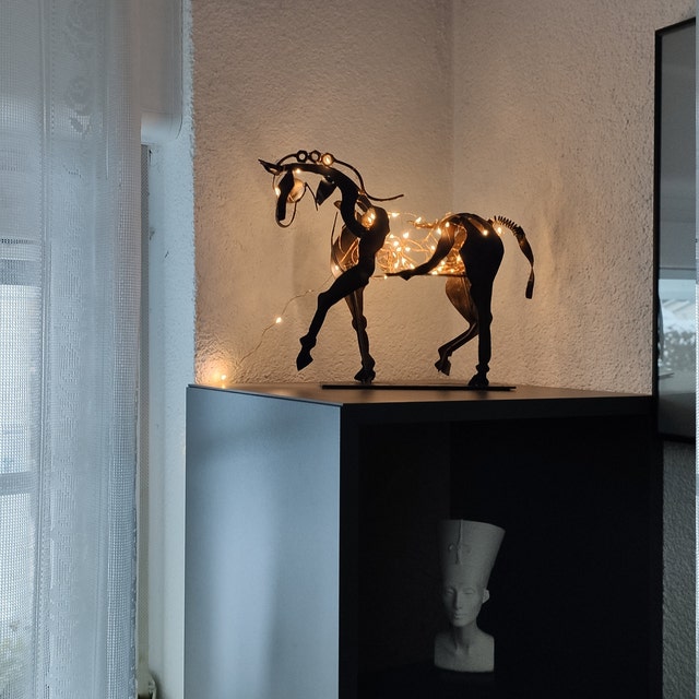 Handcrafted metal horse statue, rustic and elegant. Unique animal figurine for timeless home decor sculpture.