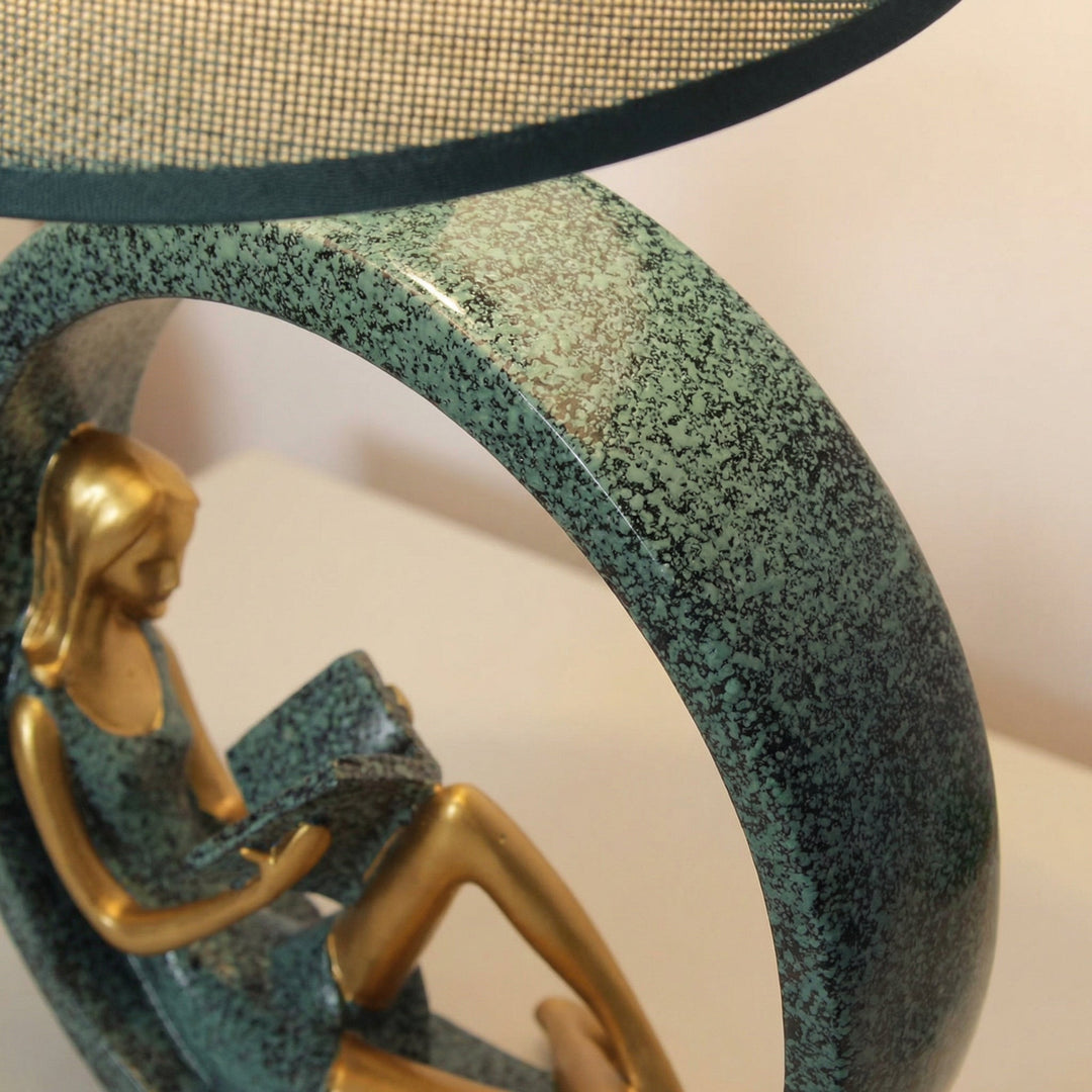Sculptural Reading Girl Table Lamp, resin base with fabric shade, perfect for bedroom ambient lighting
