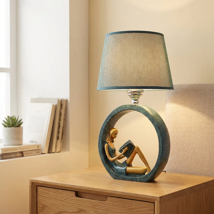 Readelle decorative table lamp featuring a sculptural girl reading figure, ideal for living room decor