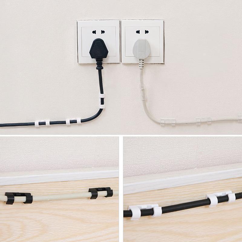 Wall-mounted wire management clips for routing electronics cables neatly & decluttering floors.