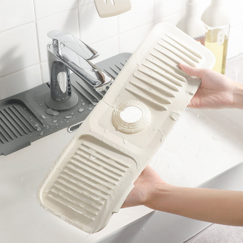 Self-draining silicone mat for kitchen countertops, ideal for dish drying & organization.