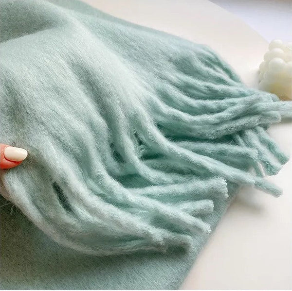 Rolled cashmere scarf, demonstrating its soft texture and compact size for travel
