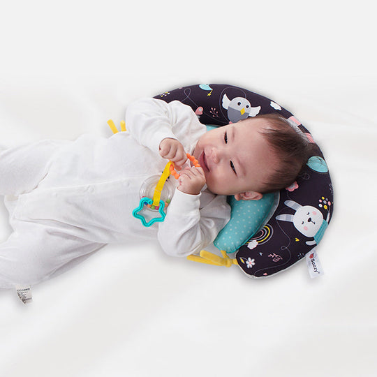 Soft Snuglo tummy time pillow for babies, promoting infant development and motor skills with comfort.