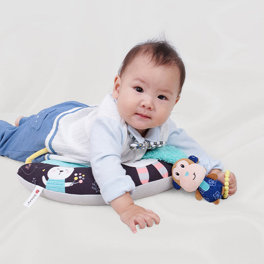 Portable Snuglo tummy time pillow for infants, providing comfort and developmental support anywhere.