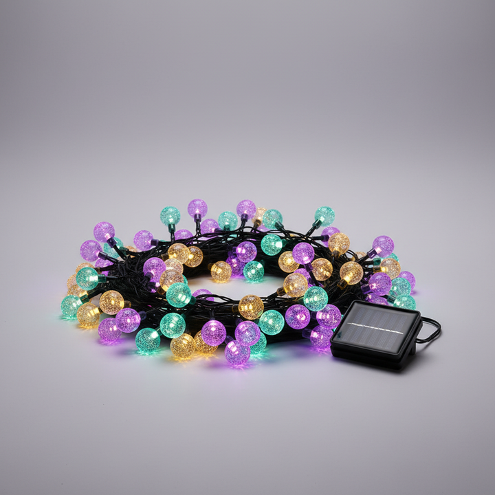 Close-up of a solar-powered fairy light string, showcasing the warm LED glow and delicate wiring.