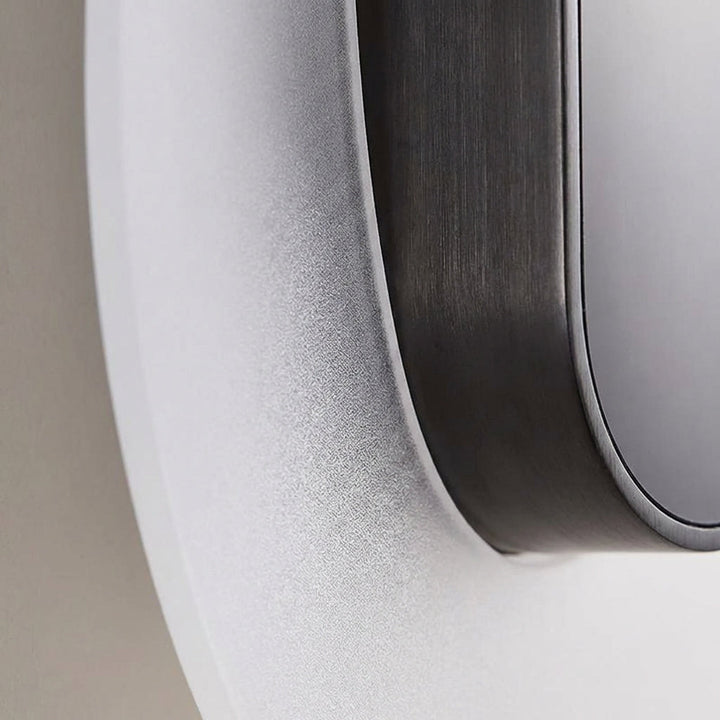 Outdoor lighting: Solenyx LED round wall sconce with sleek modern design on an exterior wall