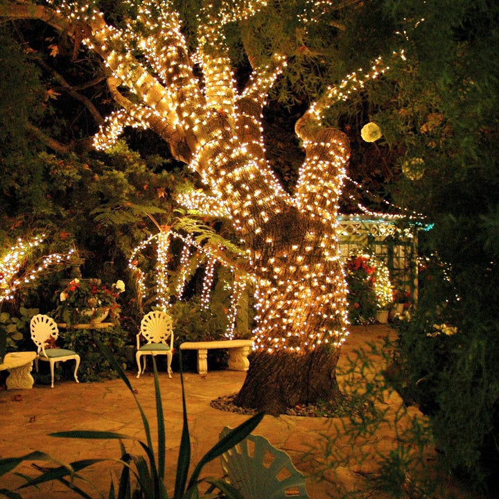 SoliGlow outdoor LED string lights illuminating a dining area, romantic garden decor.