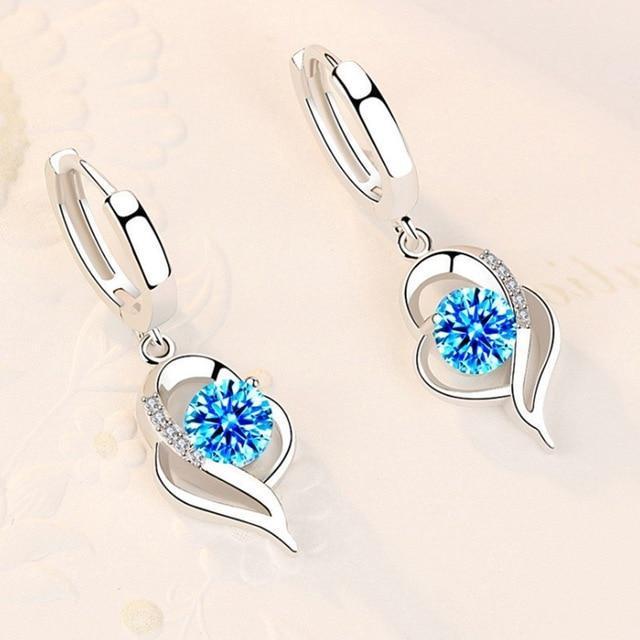 Sparkling sterling silver dangle earrings for women, featuring brilliant zirconia flower design. Elegant floral jewelry.