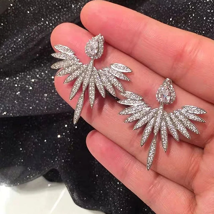 Sterling silver angel wing stud earrings for women, featuring elegant design and sparkling zirconia.