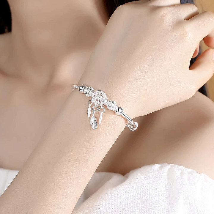 Detailed sterling silver dreamcatcher bracelet, adjustable for comfort & spiritual protection.