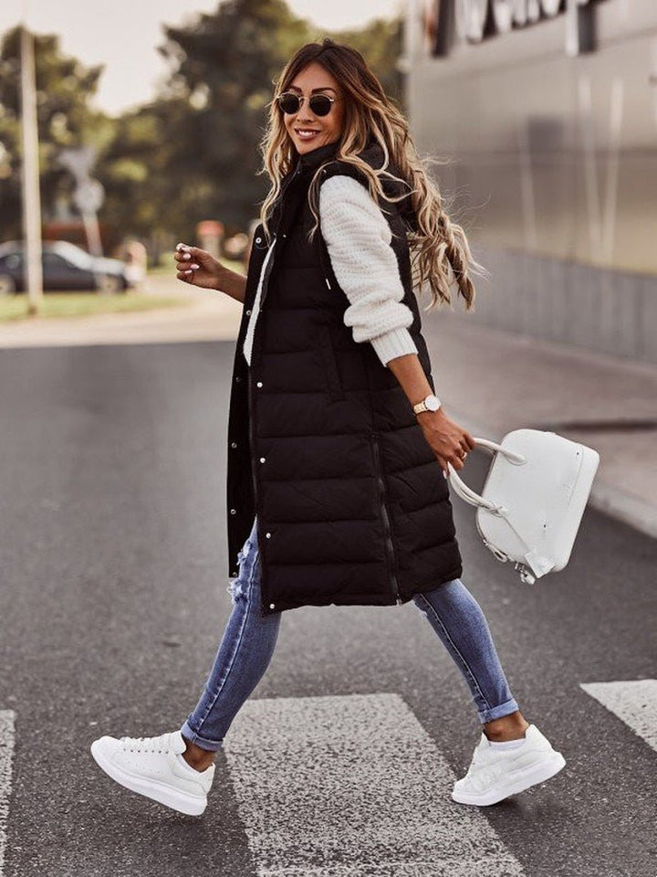 Warm knee-length padded vest for women, ideal autumn fashion & winter outerwear piece.