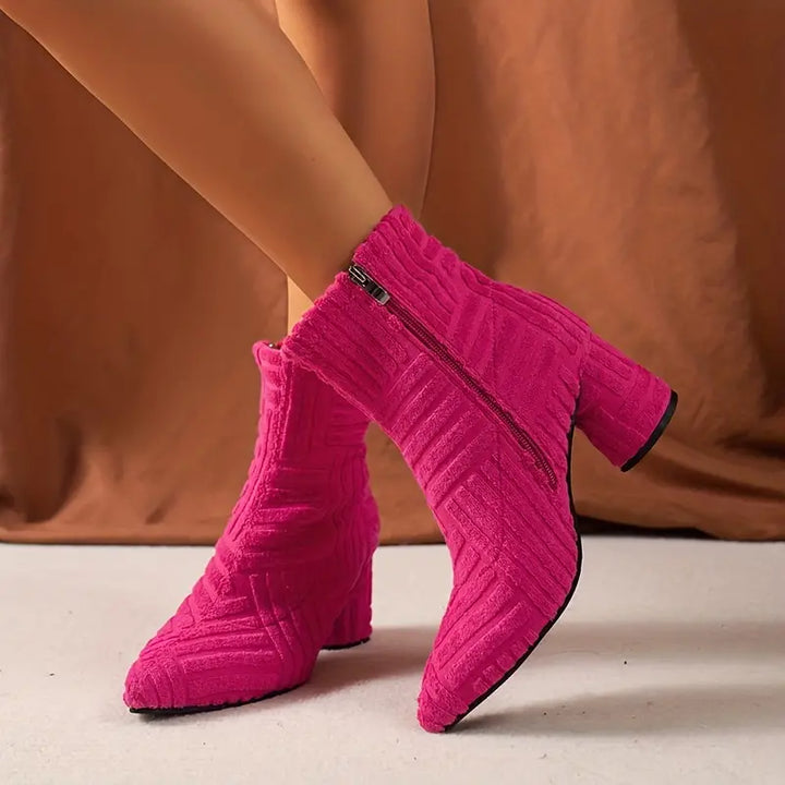 Women's black block heel ankle boots with a convenient side zip closure and sleek pointed toe.