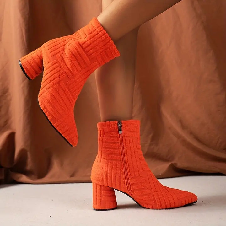 Fashionable women's black block heel ankle boots featuring a chic pointed toe and platform sole.