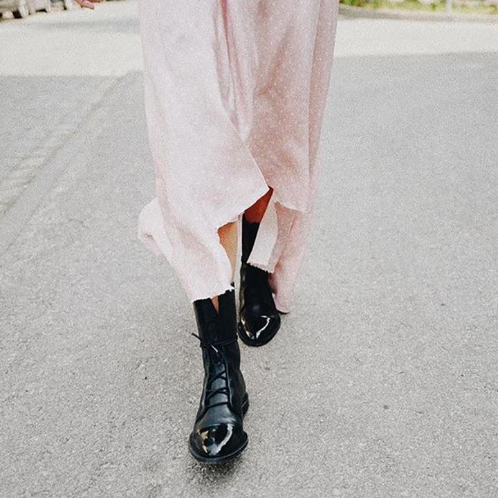Woman wearing Liana stylish brown high boots, versatile footwear for comfort and fashion.