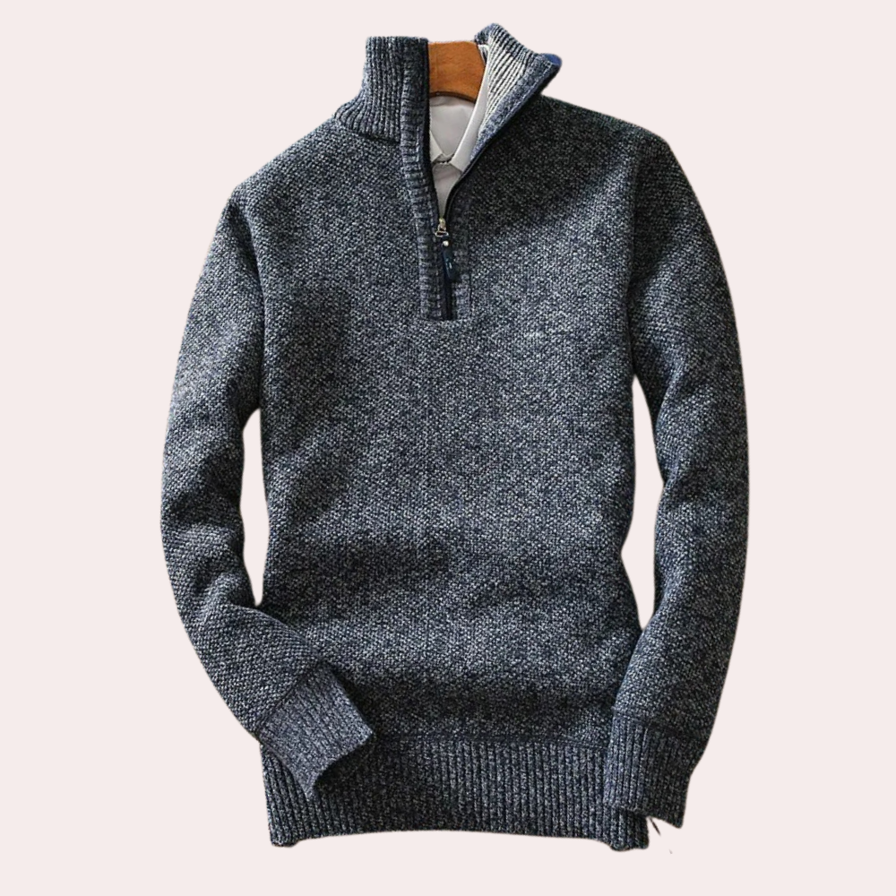 Close-up of a men's high neck zip sweater, highlighting the warm fabric and modern collar detail.