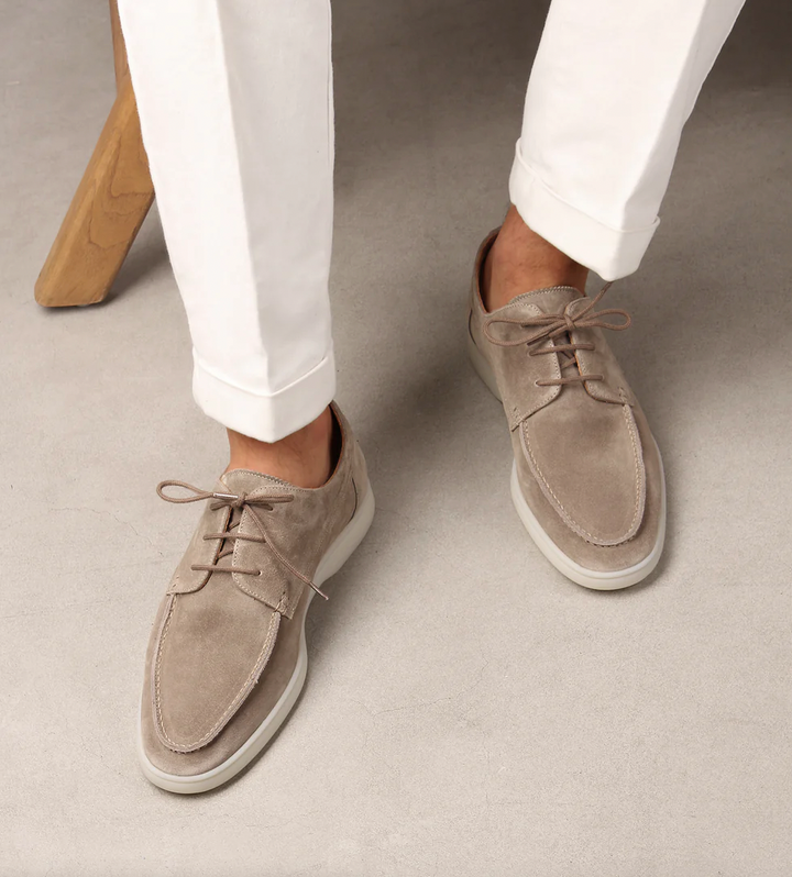 Close-up of premium leather men's loafers, highlighting intricate stitching & sophisticated design.