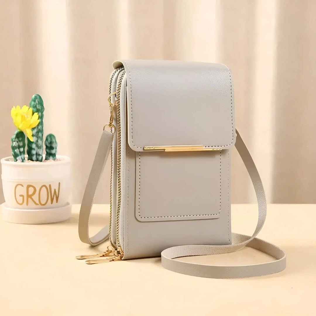 Modern grey anti-theft women's leather crossbody bag with RFID, secure for urban travel.