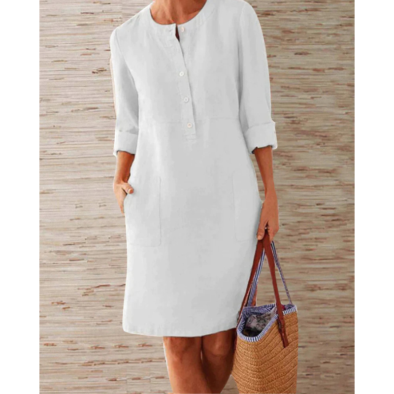 Chic women's summer dress featuring a round neck, long sleeves, and convenient pockets. Stylish knee-length design.