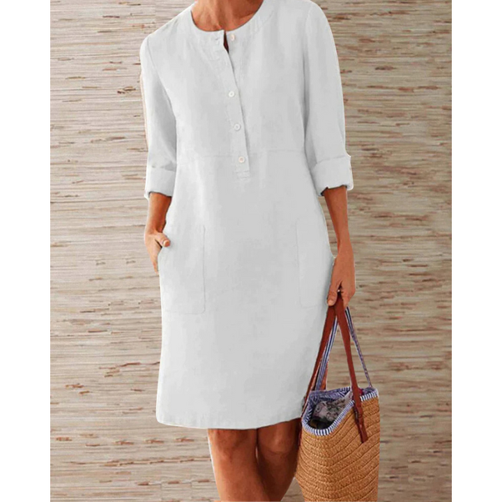 Chic women's summer dress featuring a round neck, long sleeves, and convenient pockets. Stylish knee-length design.