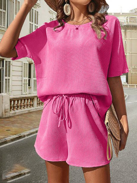 Casual women's summer shorts set featuring a breathable short sleeve top & elastic waist shorts.