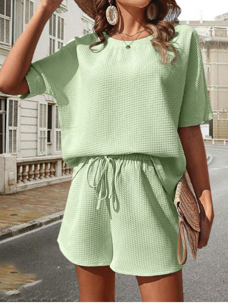 Chic women's two-piece summer outfit: comfortable short sleeve top & matching elastic waist shorts.