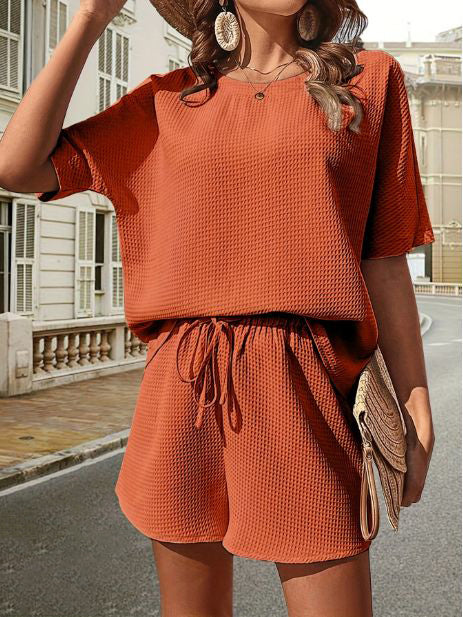 Versatile women's summer set: casual top & shorts, great for loungewear, beach, or travel.
