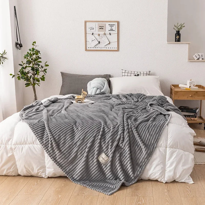 Folded luxury flannel throw, ready for cozy comfort in a stylish living room.