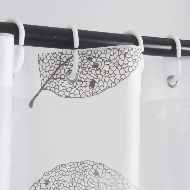 AquaLeaf shower curtain, quick-dry and transparent with a serene leaf motif, includes hooks. Bathroom decor.