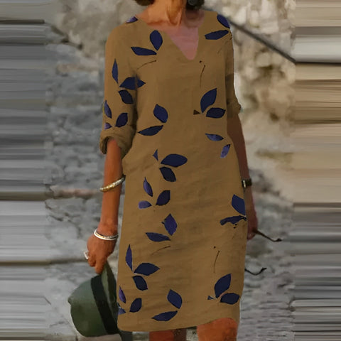 Trendy women's midi summer dress with elegant green leaf print, perfect for casual wear or a stylish vacation outfit.