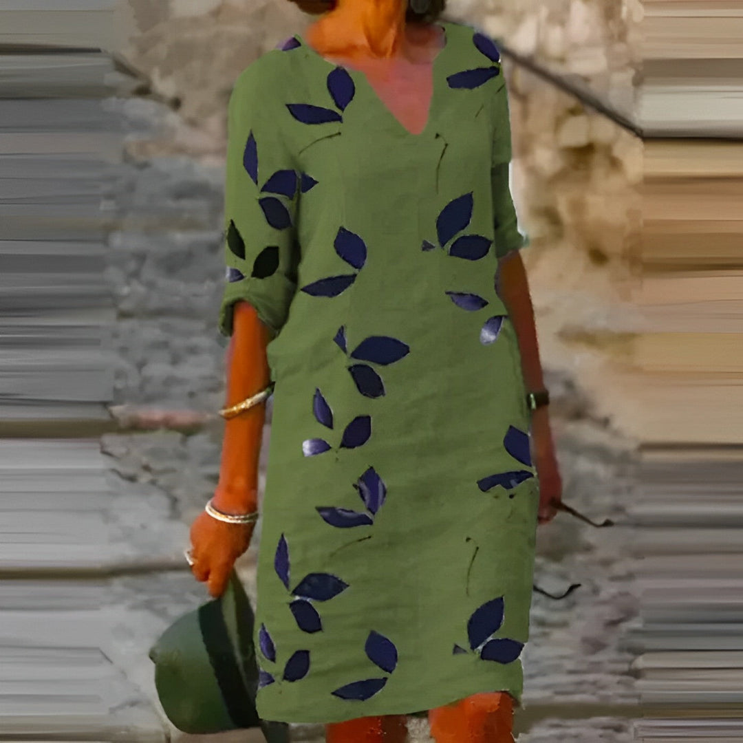 Stylish women's summer midi dress featuring a vibrant leaf print. Great for vacation, beach, or trendy casual outings.