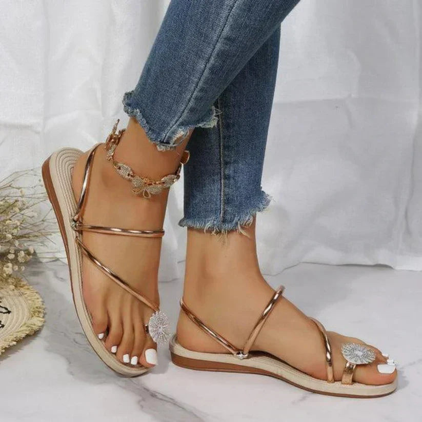 Comfortable flat sandals for women with an elegant open-toe design and distinctive snowflake detail.