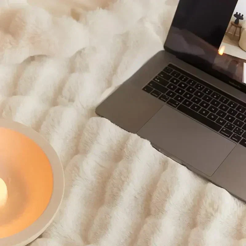 Person snuggling with an ultra-soft plush throw blanket, emphasizing its cozy and comforting feel.
