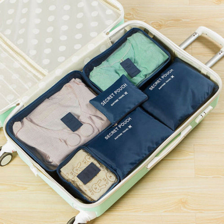 Two open packing cubes showing organized travel essentials, waterproof fabric
