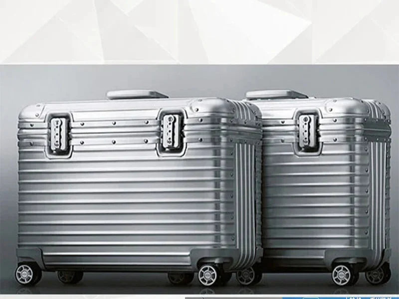 Ergonomic telescopic handle extended on a unisex aluminum-magnesium hardshell carry-on suitcase, easy grip.